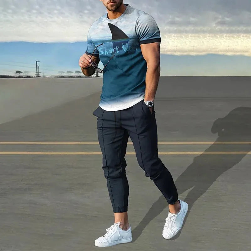 Man wearing a printed short-sleeve t-shirt and matching trousers from a cotton-like men's tracksuit set.