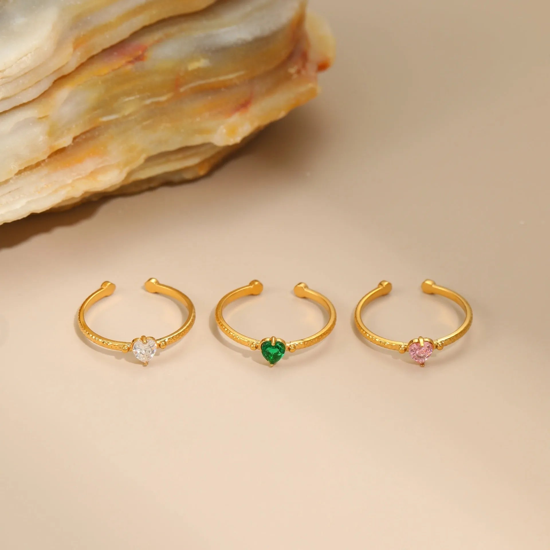 Geometric open-ended ring with heart-shaped zircon inlay in stainless steel