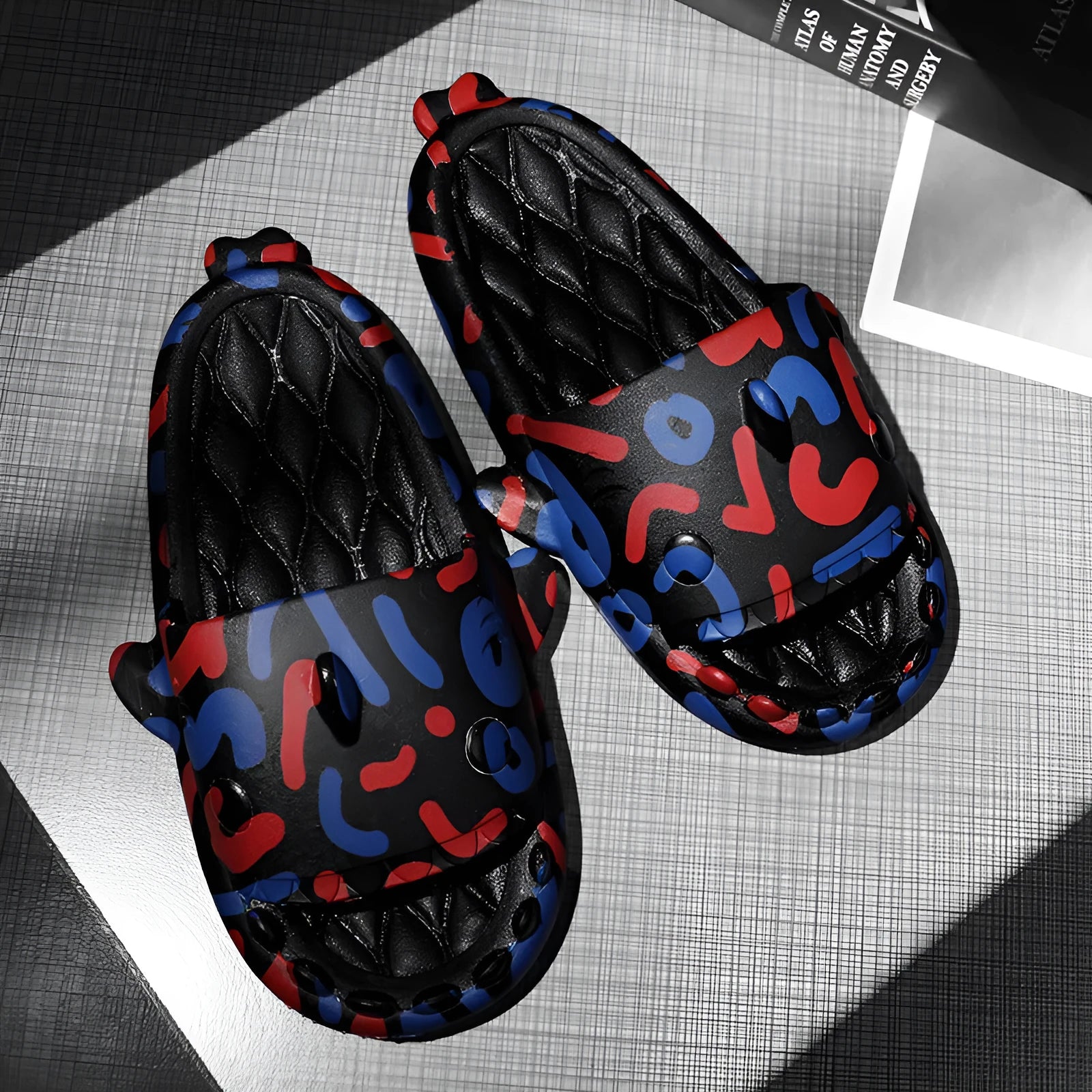 Open-toe EVA foam home slippers with shark design in beige, black, grey, and white colours.