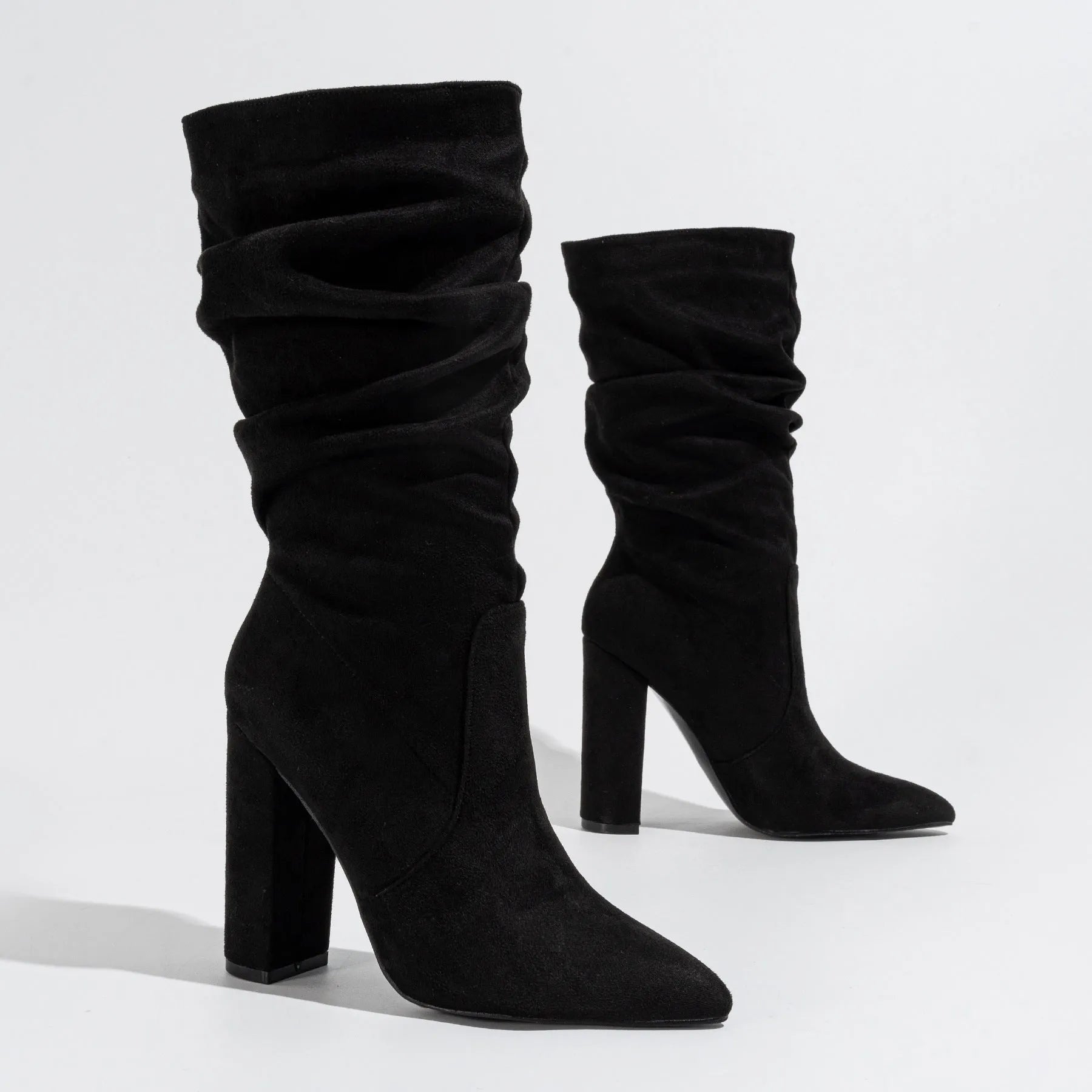 Women's black suede chunky heel pointed toe boots with super high heels and mid-calf length
