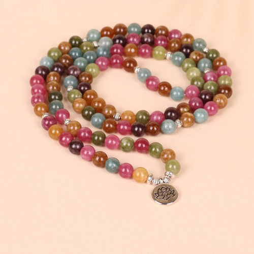 108 bead multi-layer bracelet with lotus pendant in Tourmaline colour and alloy construction.