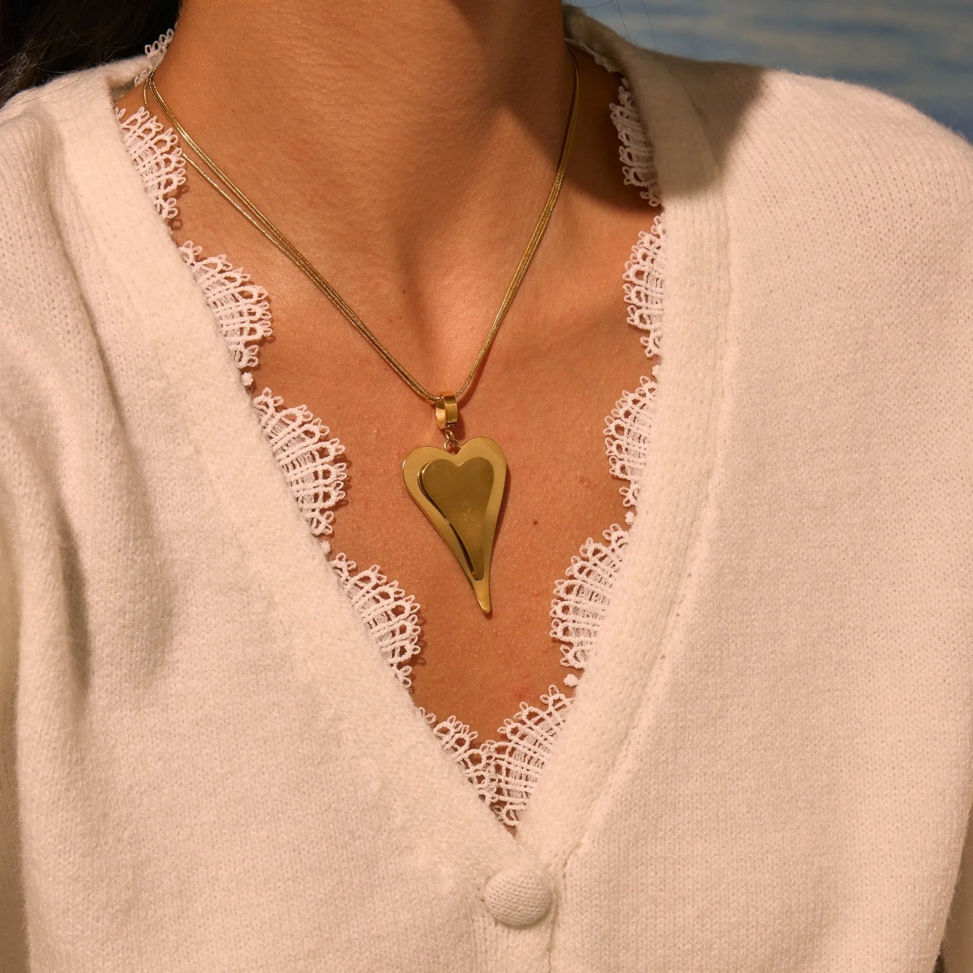 Gold stainless steel necklace with double heart pendant on snake bones chain