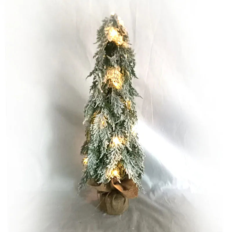 Small 24-inch white artificial Christmas tree with LED lights and snow spray on plastic branches