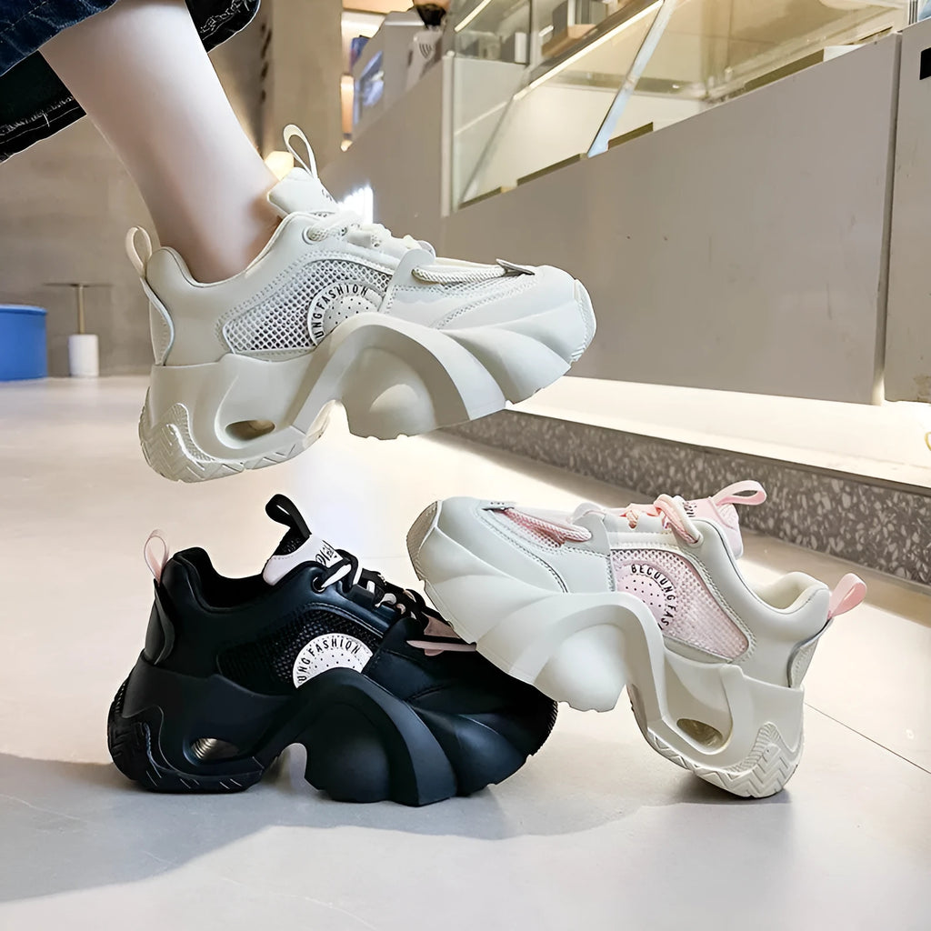 Women's pink casual sneakers with cross strap design and thick sole showing side profile