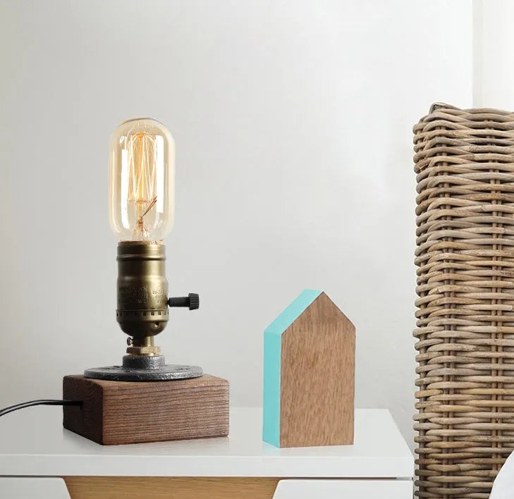 Small wooden and iron water pipe shaped table lamp on a table