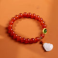 Handmade women's bracelet with red agate and amber Maitreya Buddha pendant.
