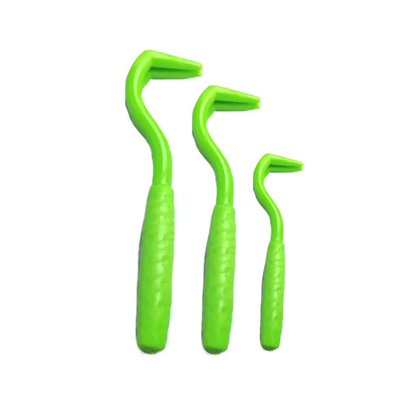 Set of three coloured plastic tick removal hooks for pets on a white background.