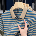 Man wearing a red striped casual short sleeve shirt with a mosaic pattern detail.