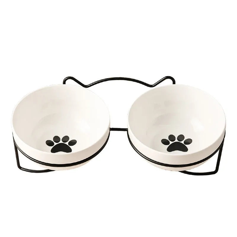 White ceramic pet bowl with cat paw print pattern in black iron frame stand