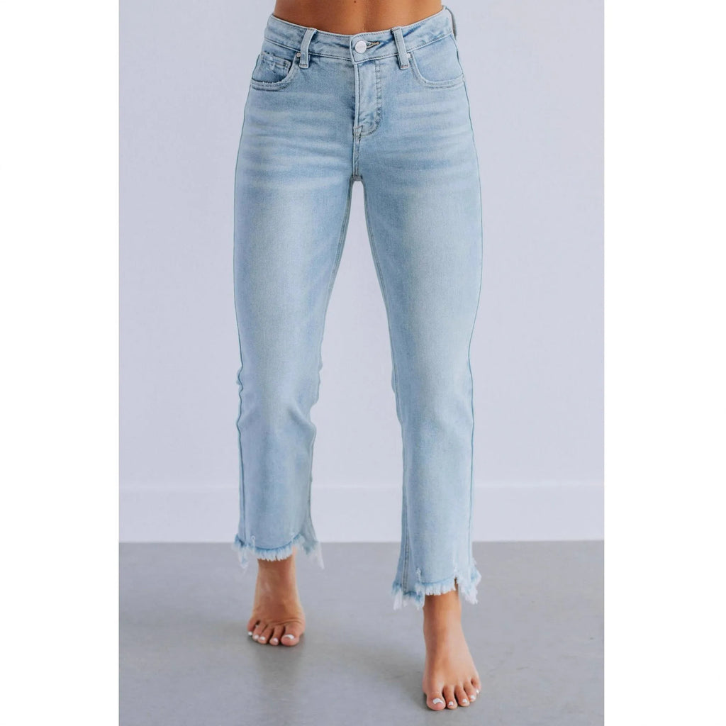 Women's solid colour denim jeans on a hanger showing hand-worn texture and available in dark blue and light blue