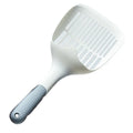 White plastic cat litter scoop with storage base on a clean surface