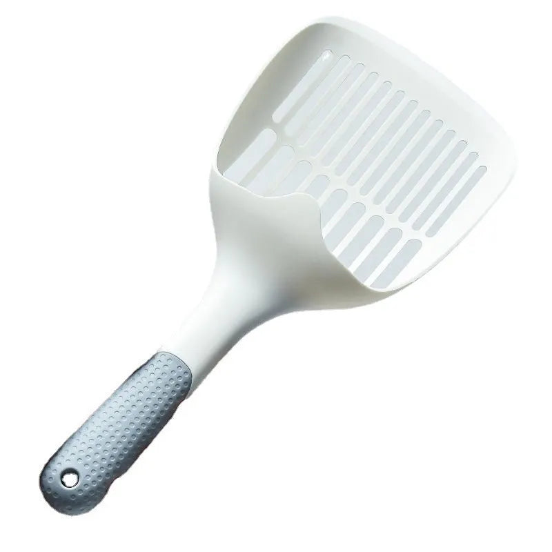 White plastic cat litter scoop with storage base on a clean surface
