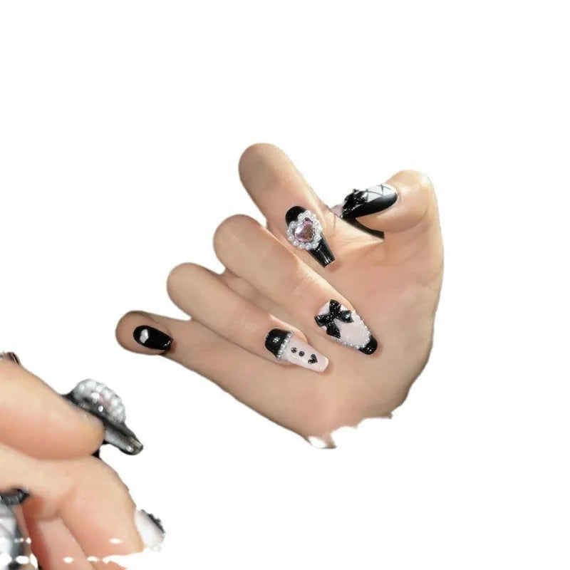 Black peach heart hand-painted detachable manicure set showing cat's eye design with bow patterns