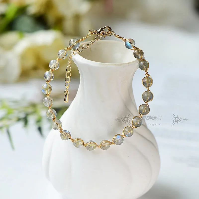 Women's blue moonstone bracelet with 6mm crystals in 14K gilded setting featuring starry sky design