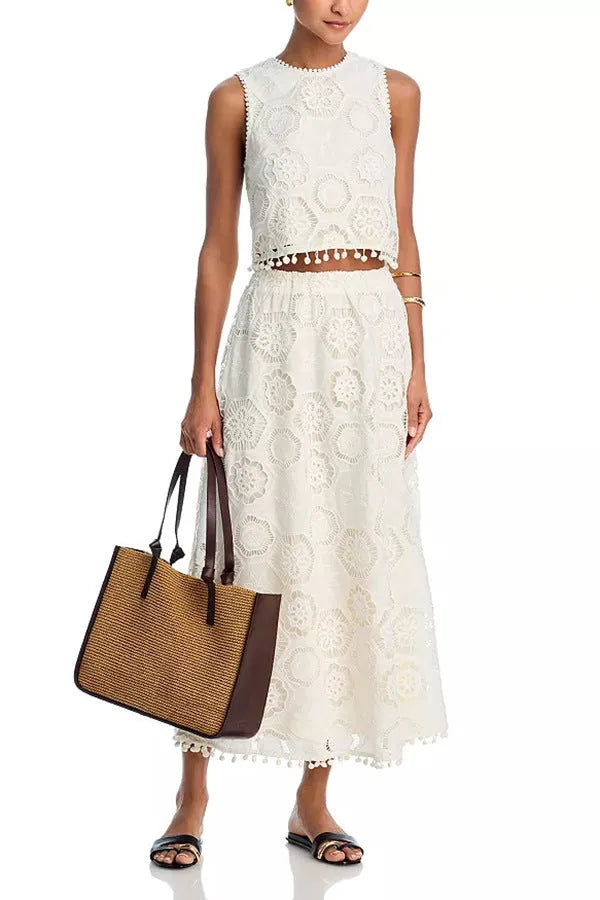 White women's retro style embroidered two-piece suit with sleeveless top and long skirt
