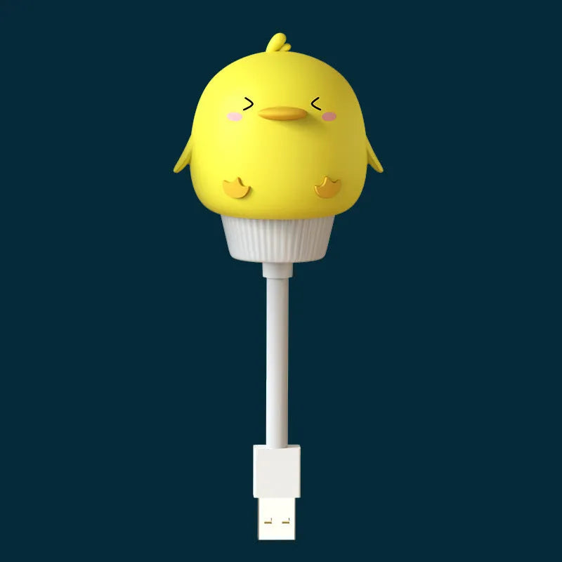Small cartoon bear-shaped USB night light with remote control on a bedside table.