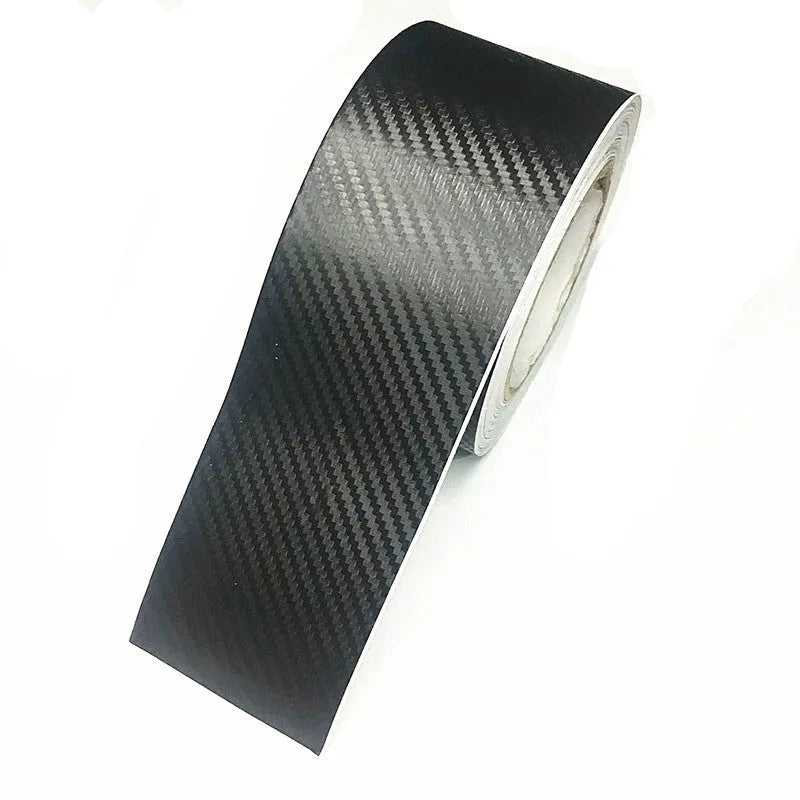 Roll of matte black carbon fibre patterned vinyl with adhesive backing for car door sill protection.