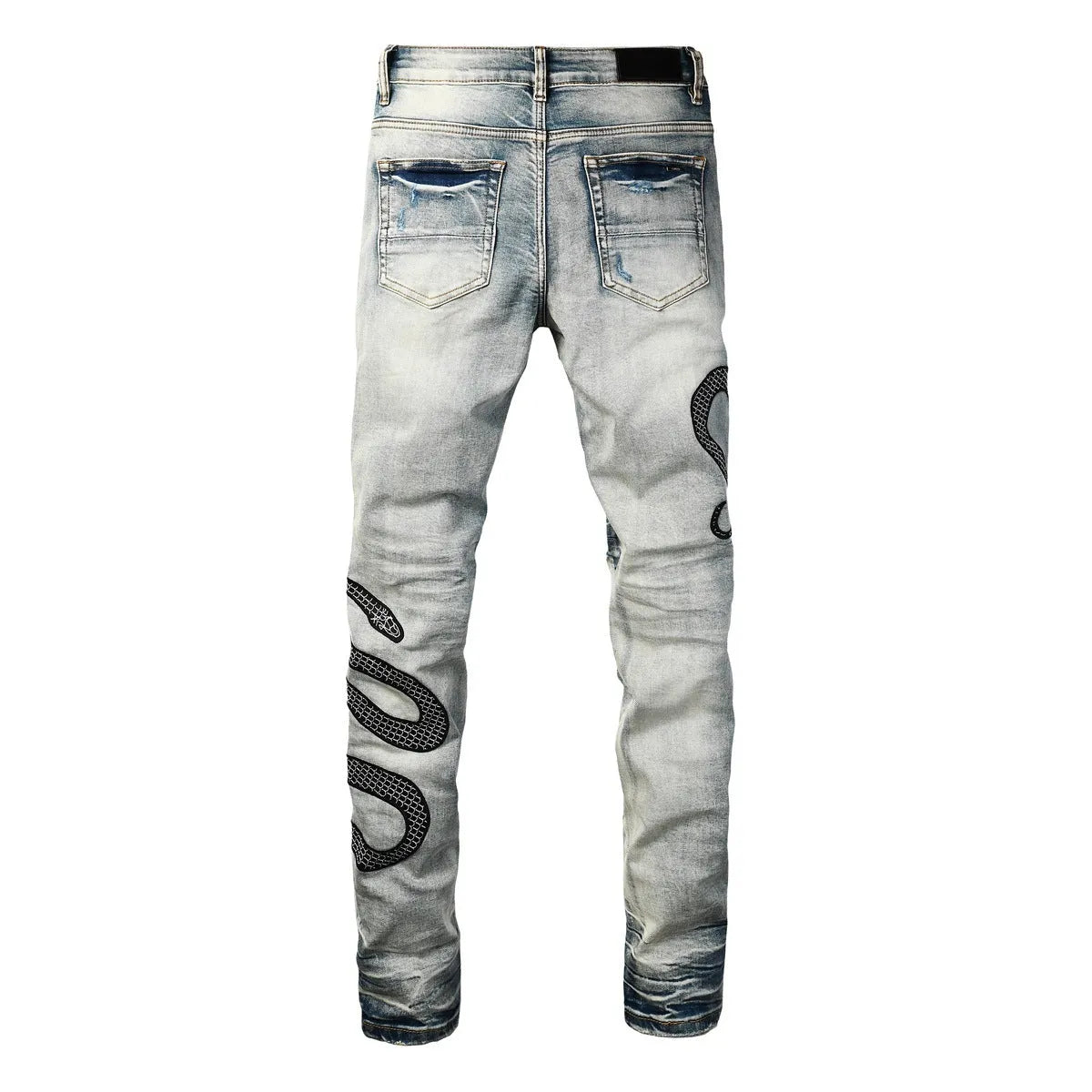 Man's blue distressed skinny jeans with a button fly and mid waist on a grey background.