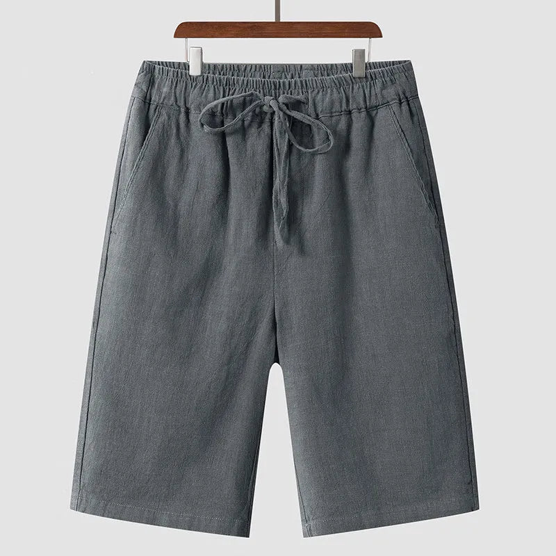 Men's linen shorts in loose cropped design with elastic waistband, shown in available colours