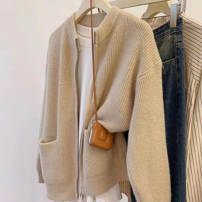 Beige viscose women's sweater coat cardigan with long sleeves laid flat.