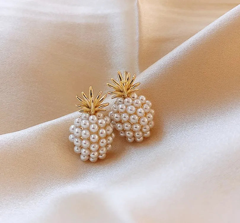 Korean style gold pineapple starfish pearl earrings made from electroplated alloy with inlaid stones.