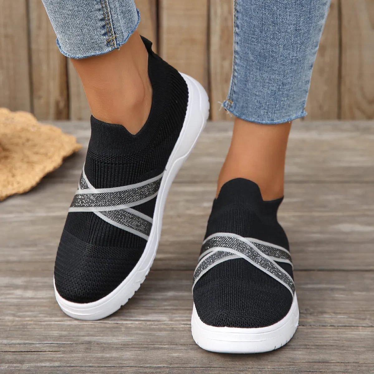 Black women's flat knit mesh shoes with tassel detail and rubber sole