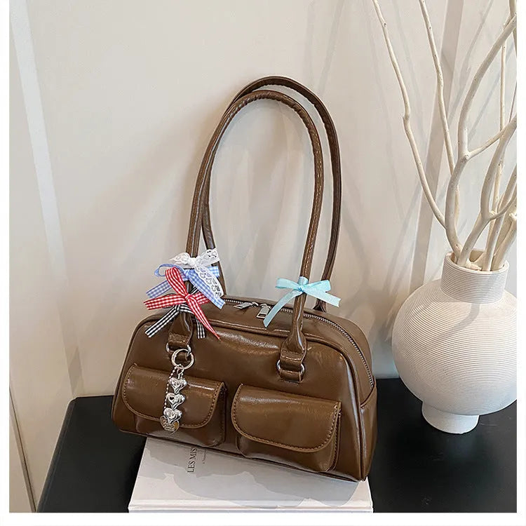 Retro pillow-shaped leather women's handbag with one shoulder underarm design in black with ribbon pendant