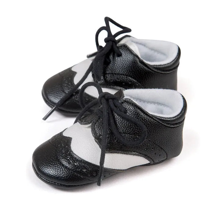 Vintage baby shoes with soft soles in light brown colour showing synthetic leather upper