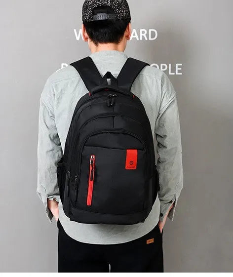 Teenage backpack in Oxford fabric showing side zipper pockets and breathable shoulder straps