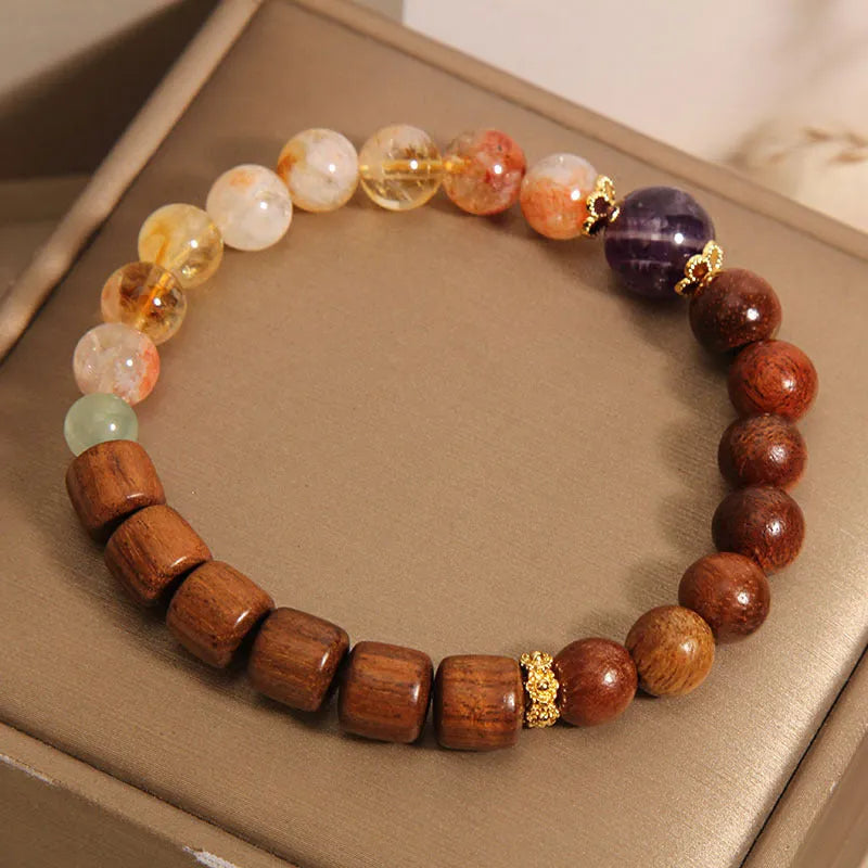 Women's adjustable crystal bracelet with yellow tower crystal, ebony amethyst, pearls, and rhinestones.
