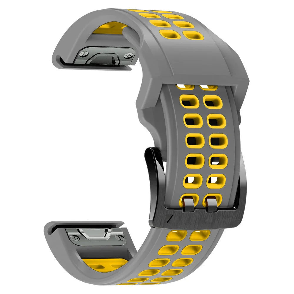 Close-up of a two-tone black and orange silicone watch strap with quick-release pins and a pin buckle.