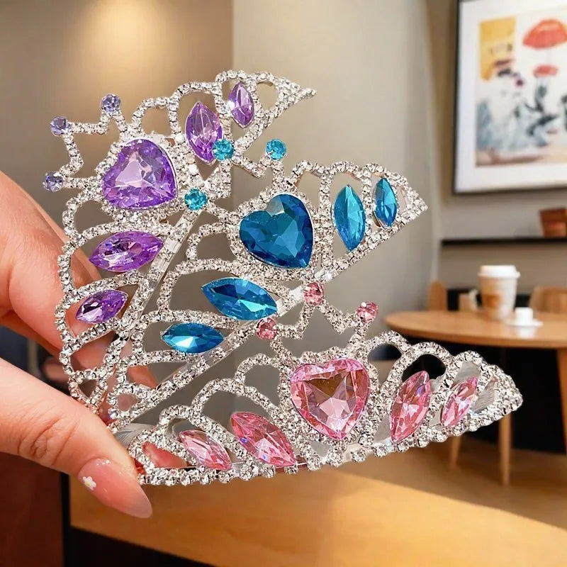 Children's metal alloy crown headdress hairband in pink, light blue, or light purple with crystal decoration.