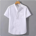 Men's casual beige linen short sleeve shirt with a stand collar and loose fit on a hanger.