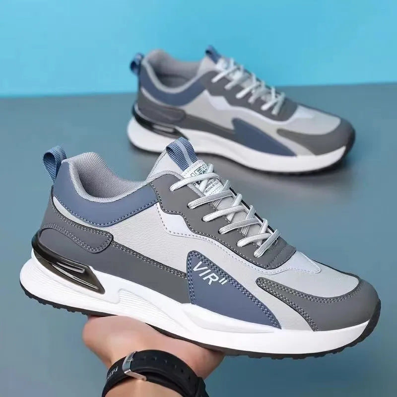 Men's colour block mesh running sneakers in black, grey, and white on a plain background.