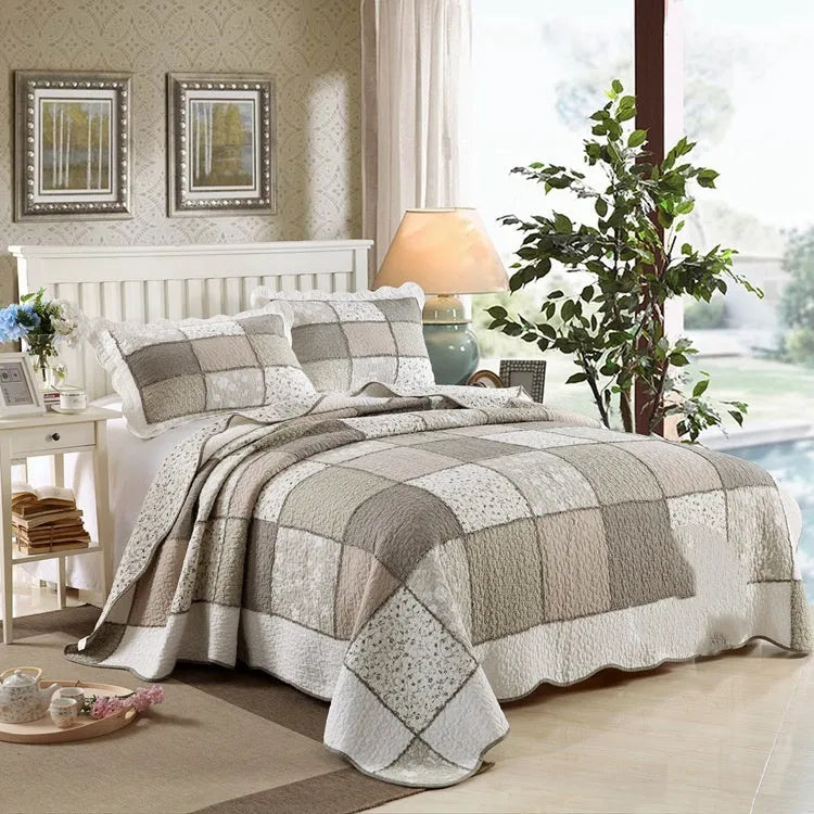 Washed pure cotton quilted bedspread set with one large cover and two pillowcases on a bed.