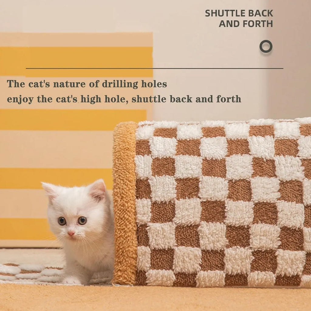Brown plush plaid cat tunnel bed with central mat on a wooden floor.