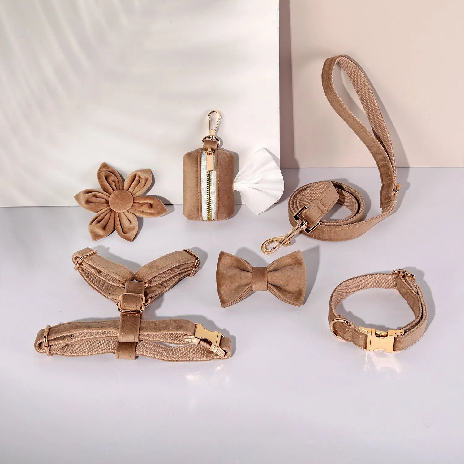Red velvet dog collar and leash set with chest strap, bow tie, and decorative flower accessories.