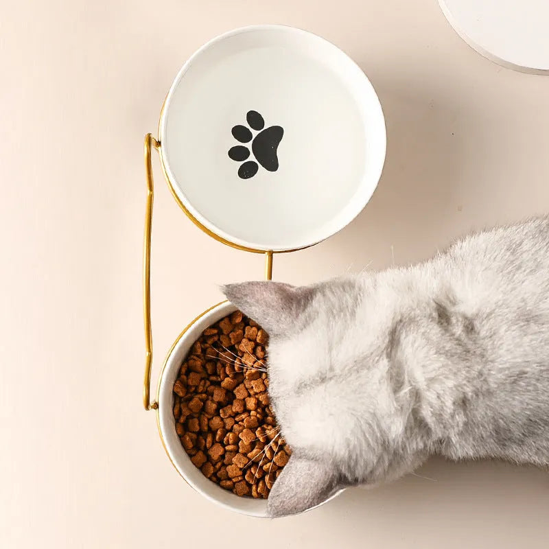 White ceramic pet bowl with cat paw print pattern in black iron frame stand