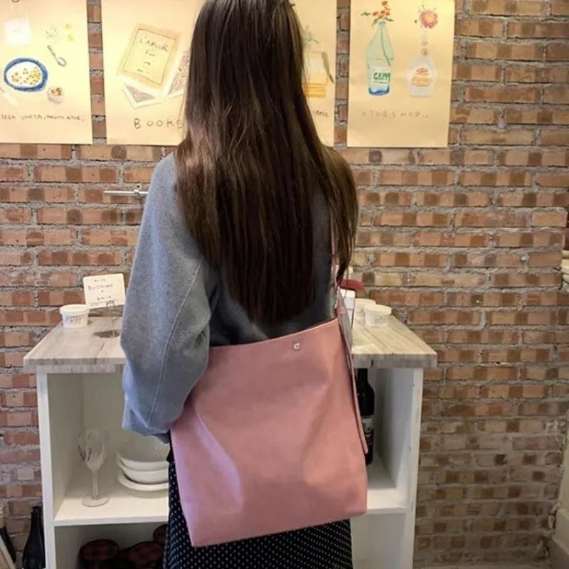Pink or brown corduroy one-shoulder commuter bag showing dimensions.