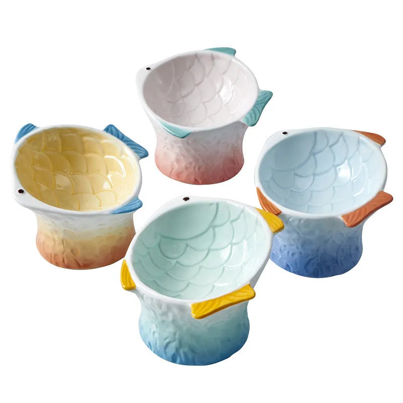 Blue fish-shaped ceramic elevated cat bowl with tilted design on a non-slip base.