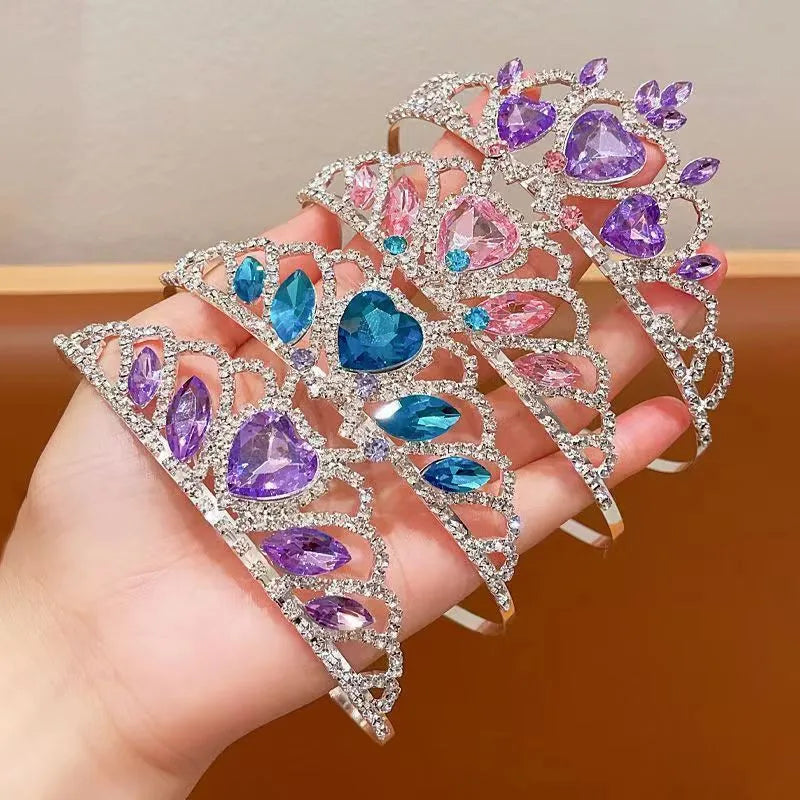 Children's metal alloy crown headdress hairband in pink, light blue, or light purple with crystal decoration.