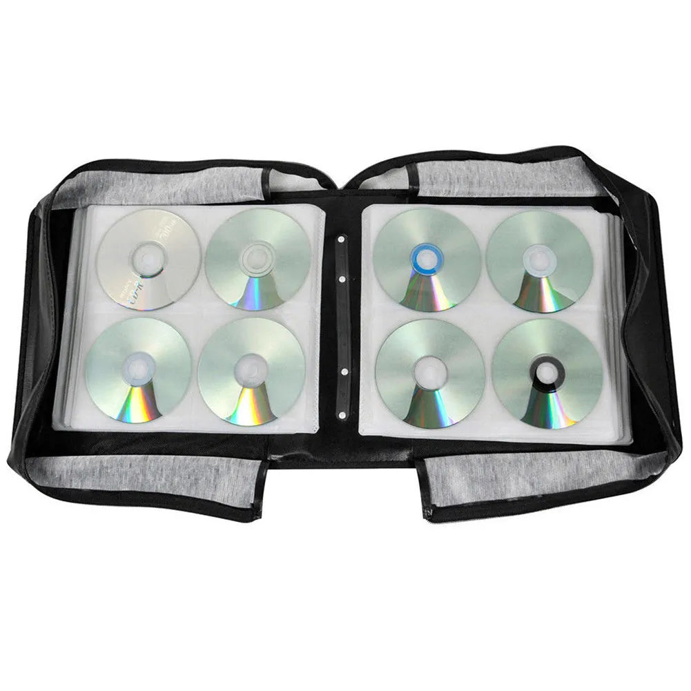Black Oxford fabric CD and DVD storage binder with a zipper and top carry strap, open to show disc sleeves.