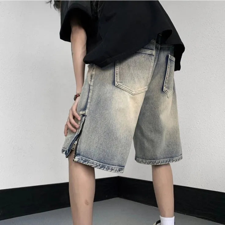 Blue distressed denim shorts with wide-leg loose fit and retro tattered styling on hanger