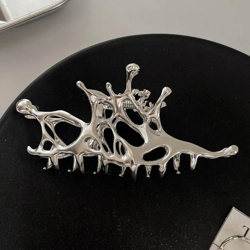 Silver metal hair claw clip assortment showing bows, waves, pearl designs, and geometric shapes from 4cm to 13.5cm