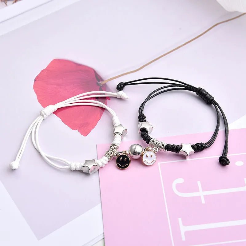 Alloy couple bracelets with magnet closure showing various design options including crown, clover, and text patterns