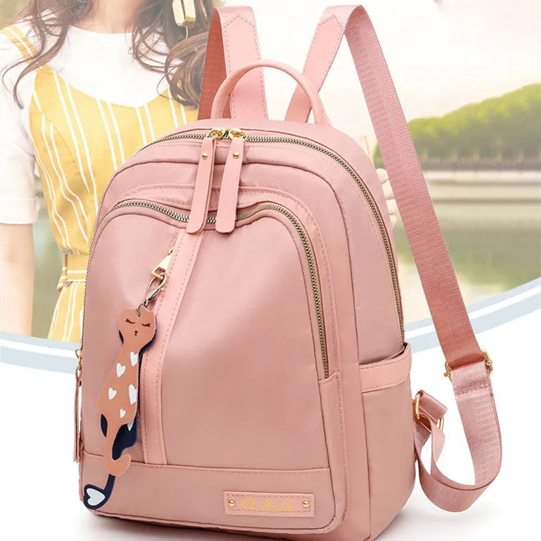 Women's black nylon casual backpack with double shoulder straps showing three-dimensional outer pockets
