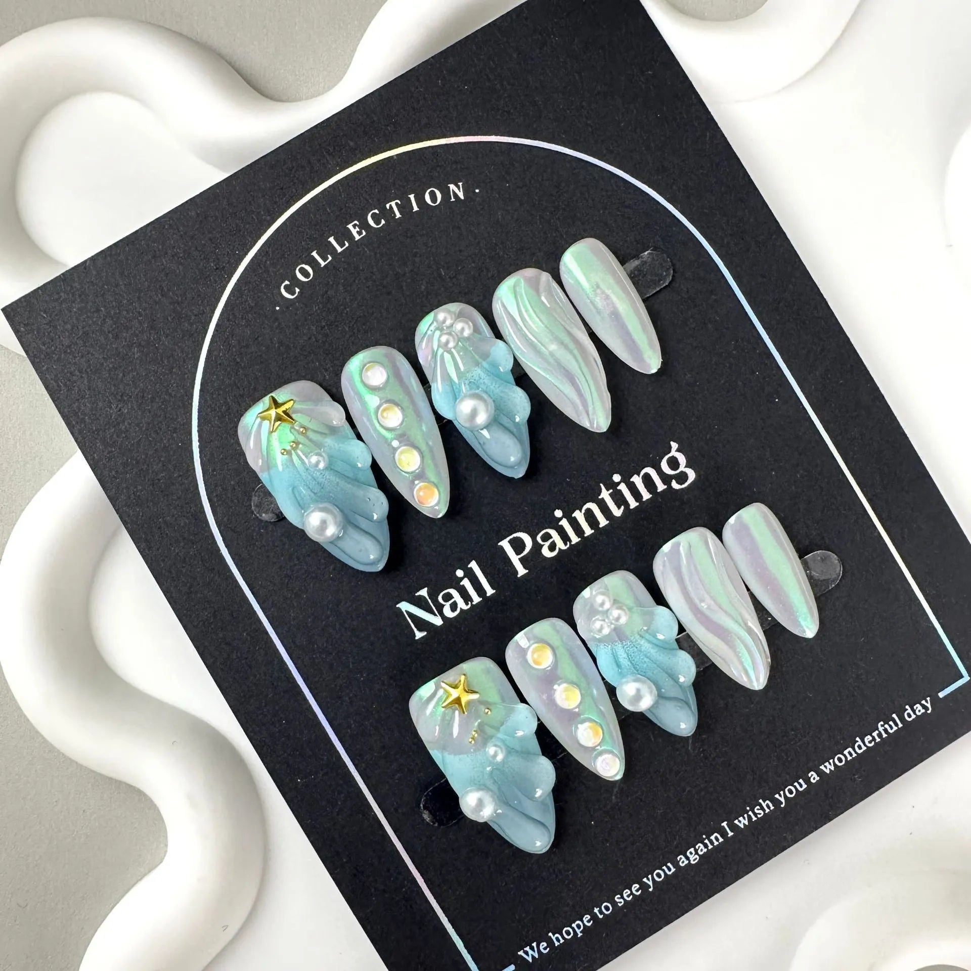 HAILANG blue plastic wearable shell nail tips in sizes XS, S, M, L on a white background.