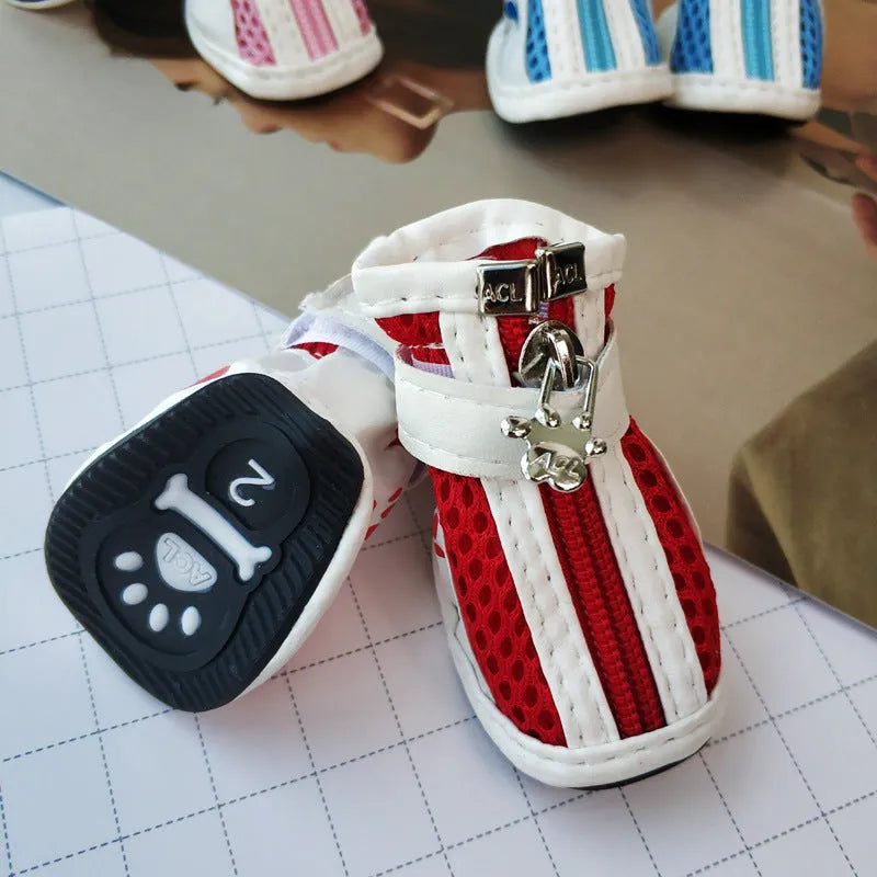 Four blue cloth dog shoes for small dogs with front zipper closure on a white background.