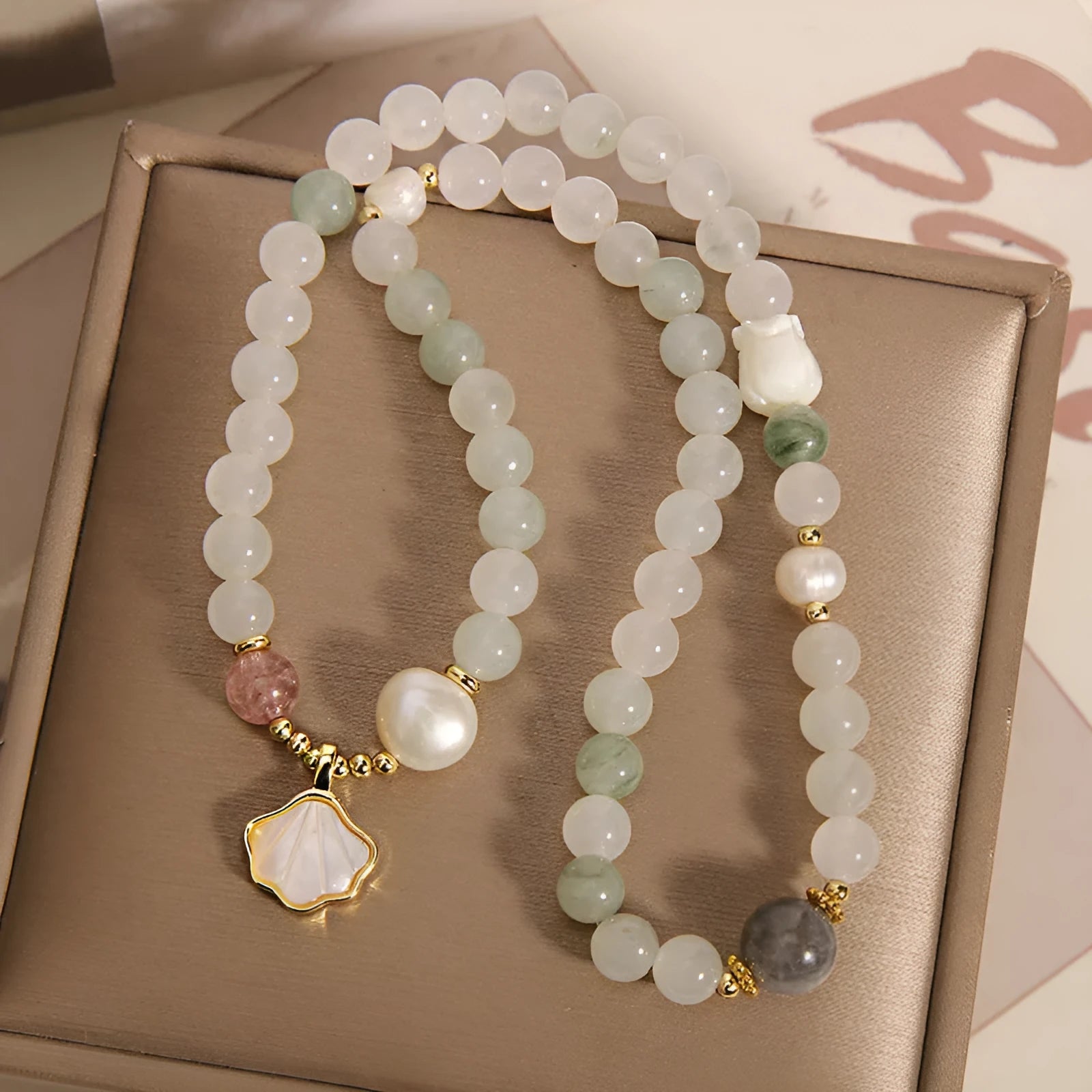 Women's crystal bracelet with an apricot leaf and jade shell pendant, gold-plated settings, and rhinestones.