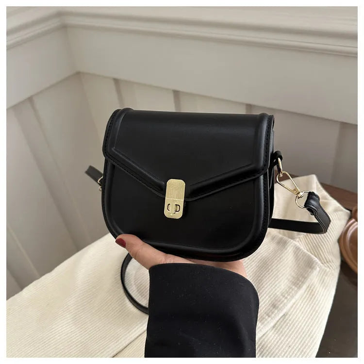 Soft textured PU shoulder messenger bag in horizontal square clamshell design.